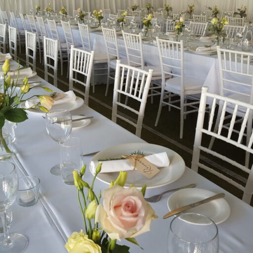 Wedding-with-10m-x-21m-pavilion-with-roof-and-wall-lining-Chiavari-Chairs-with-White-Cushion-White-Linen-Crockery-Cutlery-and-Glassware