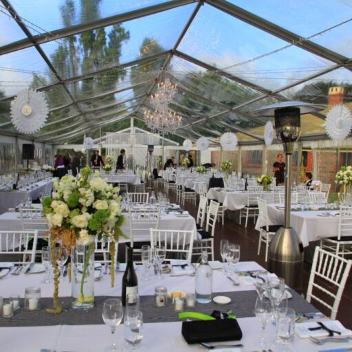 Wedding-10m-x-24m-Clear-Pavilion-with-White-Chiavari-Chairs-with-Black-Cushions-Wooden-Flooring-and-Chandeliers