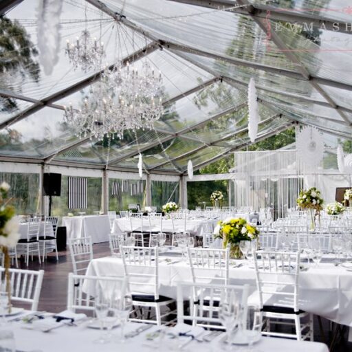 Wedding-10m-x-24m-Clear-Pavilion-with-White-Chiavari-Chairs-with-Black-Cushions-Wooden-Flooring-and-Chandeliers