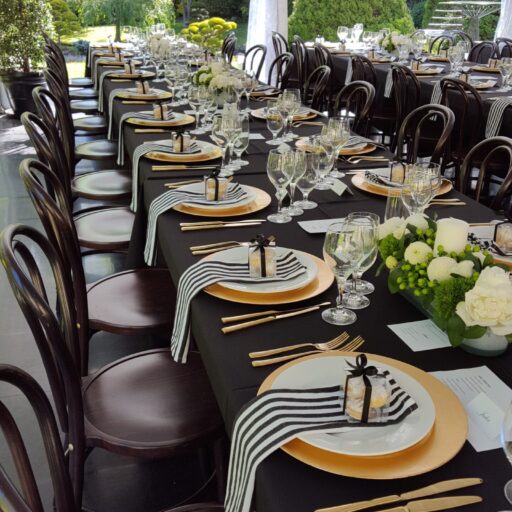 Wedding-at-beechwood-gardens-with-a-10m-x-18m-solid-toof-pavilion-with-Roof-Lining-Bentwood-Chairs-Black-Linen-and-Gold-Crockery-and-cutlery
