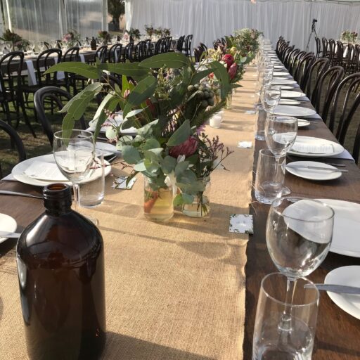 Port-Elliot-Wedding-Bubblewrap-Events-10m-x-24m-Clear-Pavilion-with-Stained-Timber-Tables-and-Bentwood-chairs