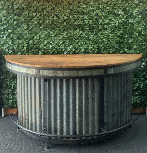 curved-wooden-top-and-corrugated-iron-bar-with-black-metal-frame-detailing-and-foot-rest